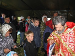 Протоиерей Александр раздаёт поминальные списки советских воинов, погибших на полуостровах